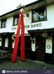 man-on-stilts-cleaning-windows-england-great-britain-KRWHMN.jpg